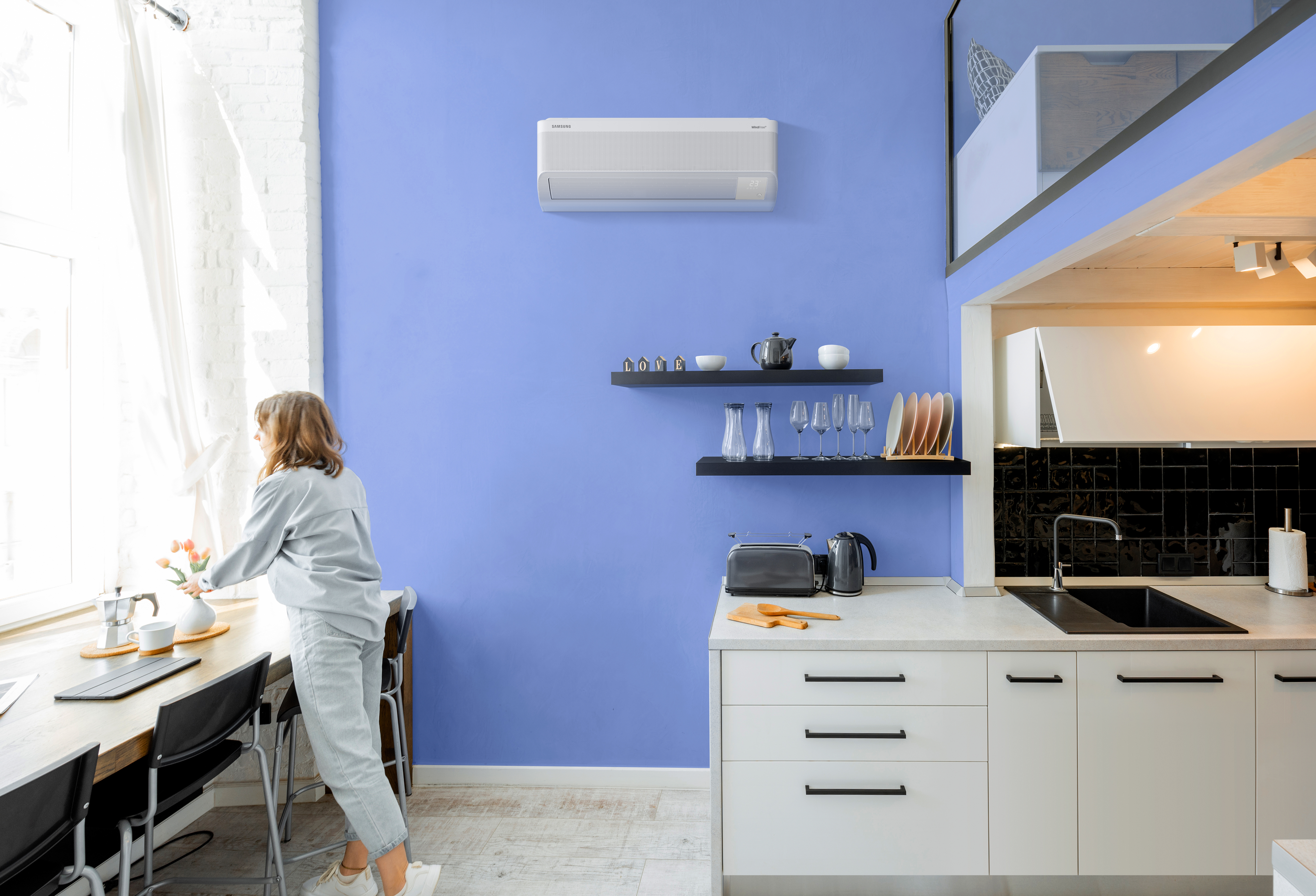 Interior view of the bright and modern kitchen with a blurred in motion human figure