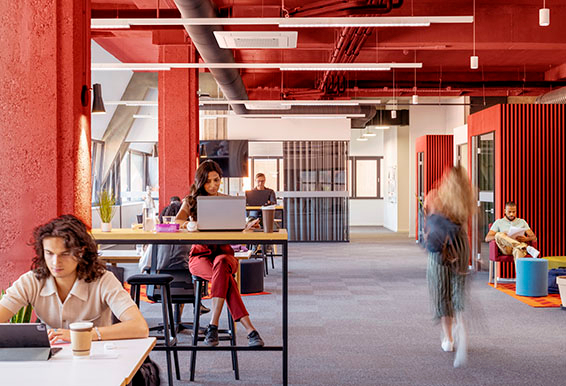 Business people using laptop and digital tablet in office.