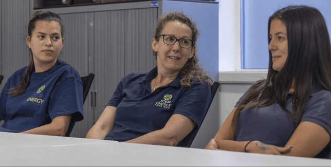 Your Energy Your Way with female trainees sitting at a desk