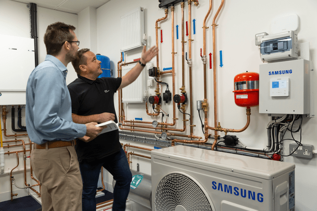 Samsung Climate Solutions training manager shows products to a customer in the Chertsey training centre