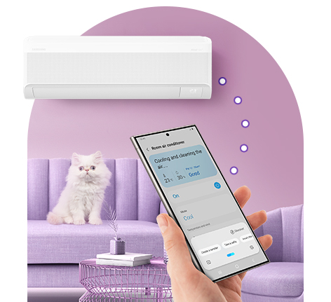 A hand holds a phone with SmartThings app on screen. It is linked to a WindFree AC behind, indicating remote control.